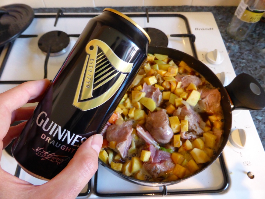 Ale (Guinness) poured in the ale (Guinness) and winter vegetables stew