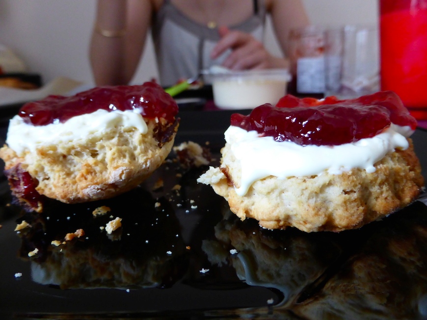Scones on a plate with clotted cream and strawberry jam